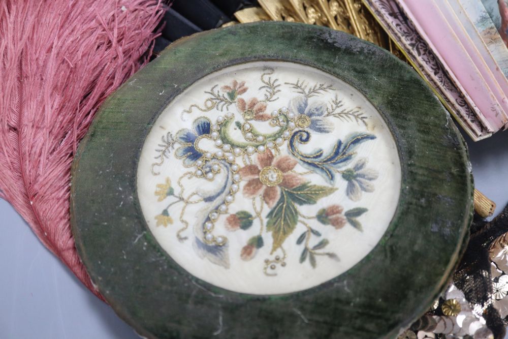 An 18th century circular framed embroidery, worked with chenille and pearls, a brise fan, two other fans, a 1930s sequin collar and an